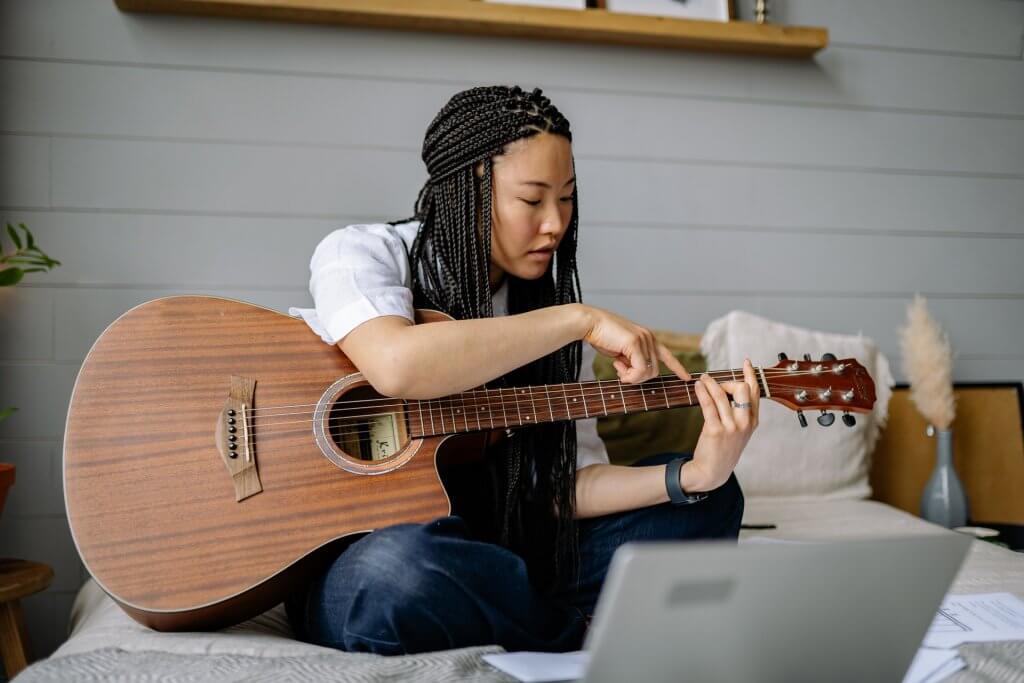 Turning Your Hobby Into a Business - Woman Playing Acoustic Guitar