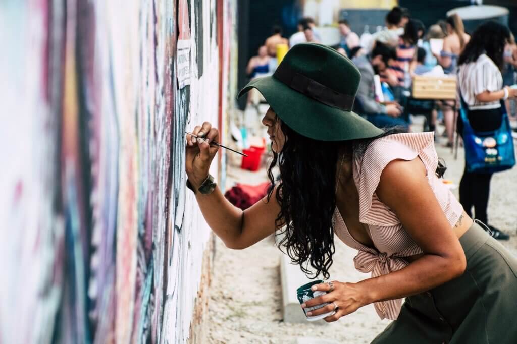 Picture of a lady Painting on a wall - Art Prize