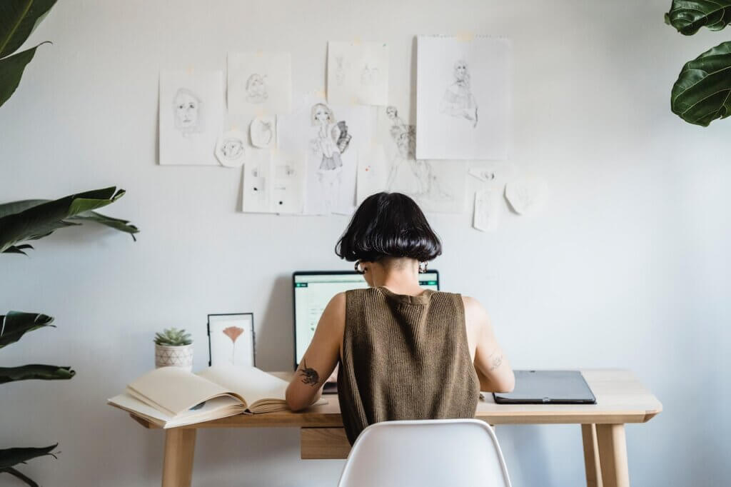 An illustrator sitting at her desk working - Illustration Contest