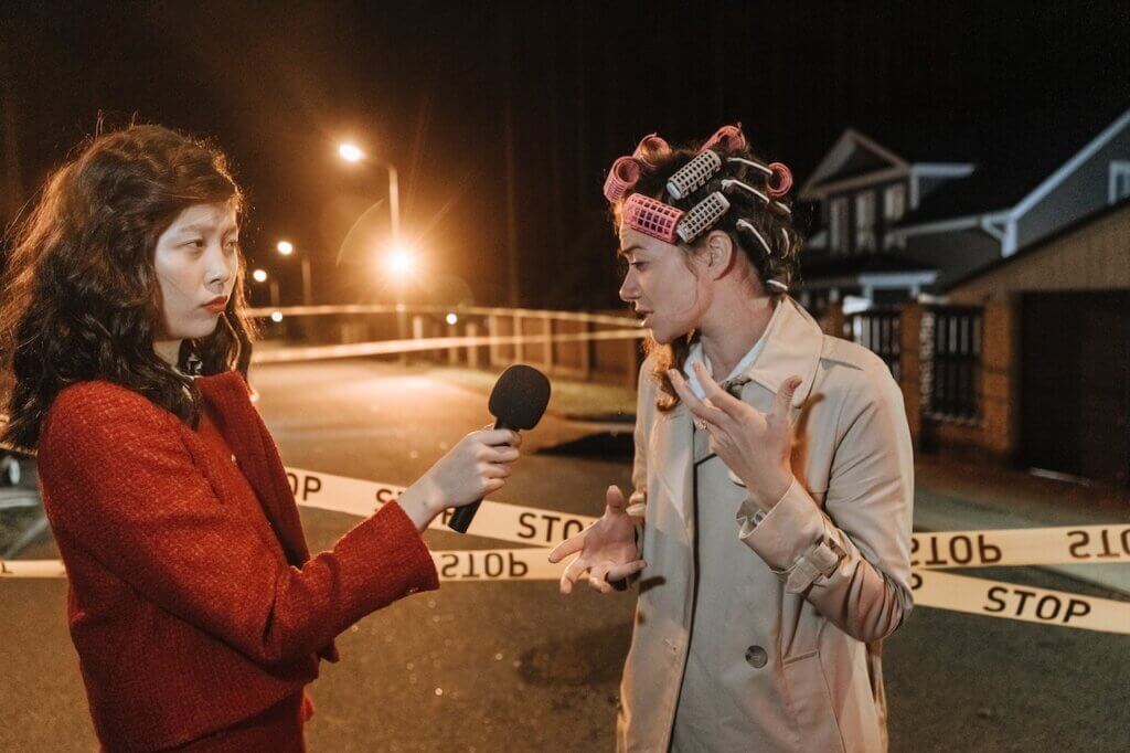A journalist interviewing a woman in an affected area - JournalismAI