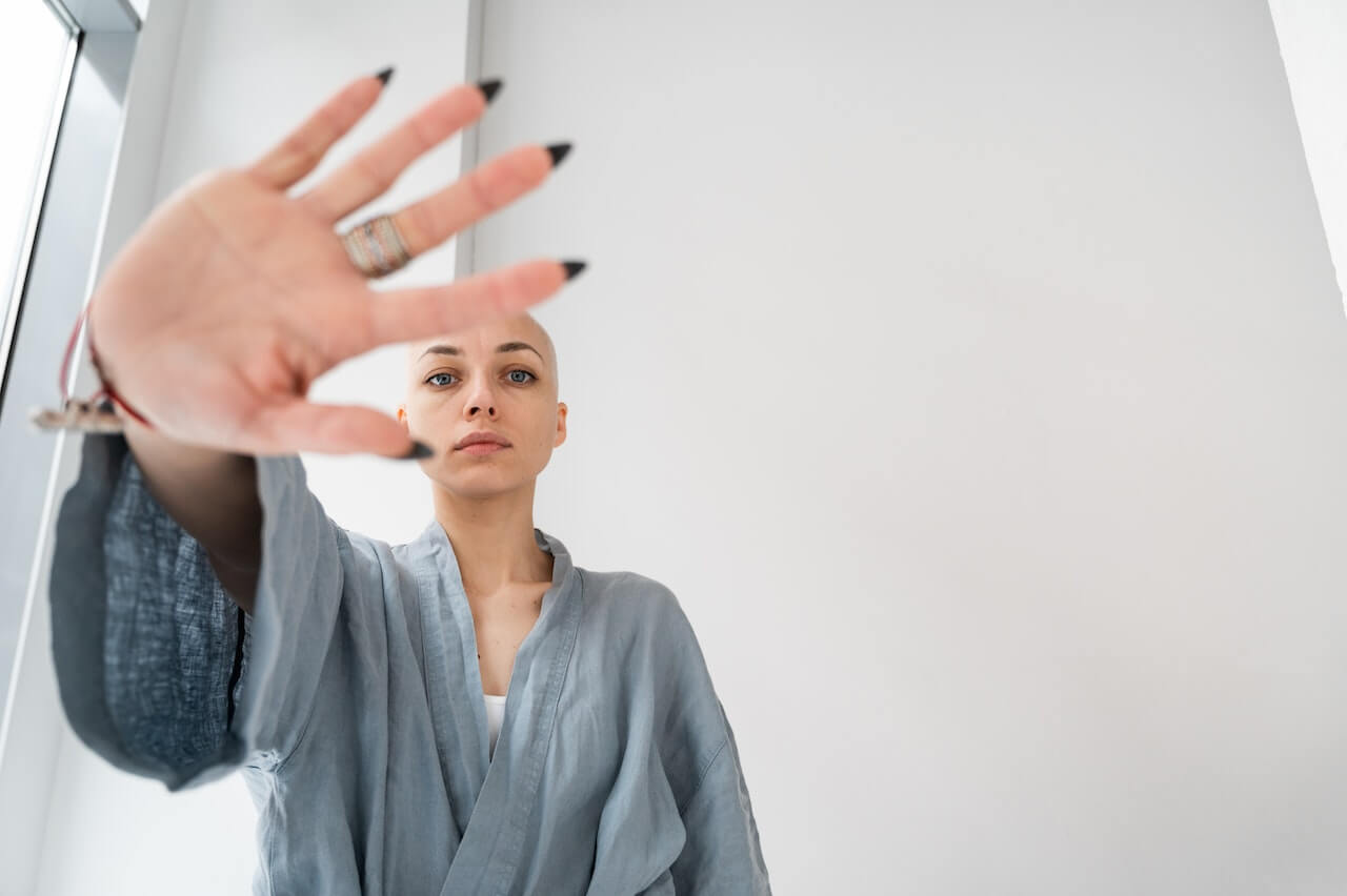 A lady posing with her 5 fingers forward in a stop sign for fake remote jobs