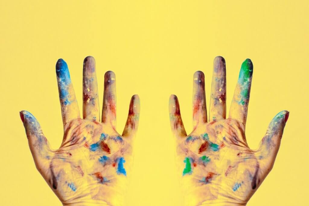 A picture showing two artist hands with paint on it
