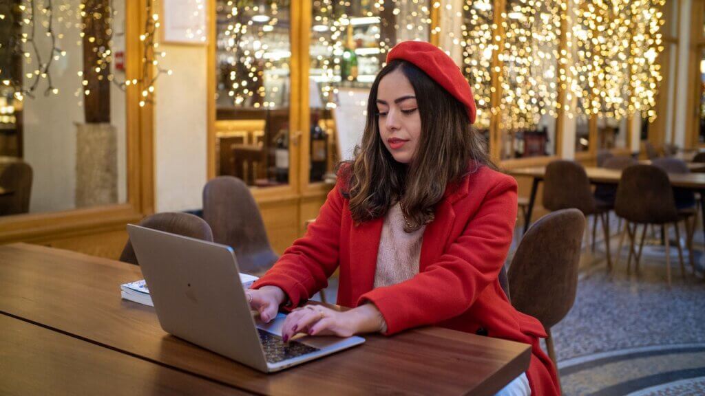 A lady working on a laptop, likely a brand manager